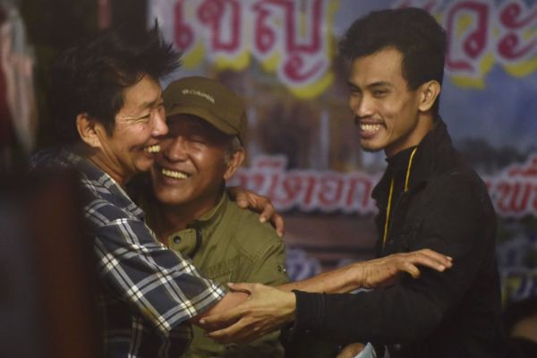 Các thành viên trong gia đình ăn mừng khi cắm trại gần hang Tham Luang vào ngày 2 tháng 7 năm 2018 sau tin rằng các chàng trai và huấn luyện viên của họ vẫn còn sống trong hang động tại Công viên Rừng Khun Nam Nang thuộc huyện Mae Sai của tỉnh Chiang Rai.