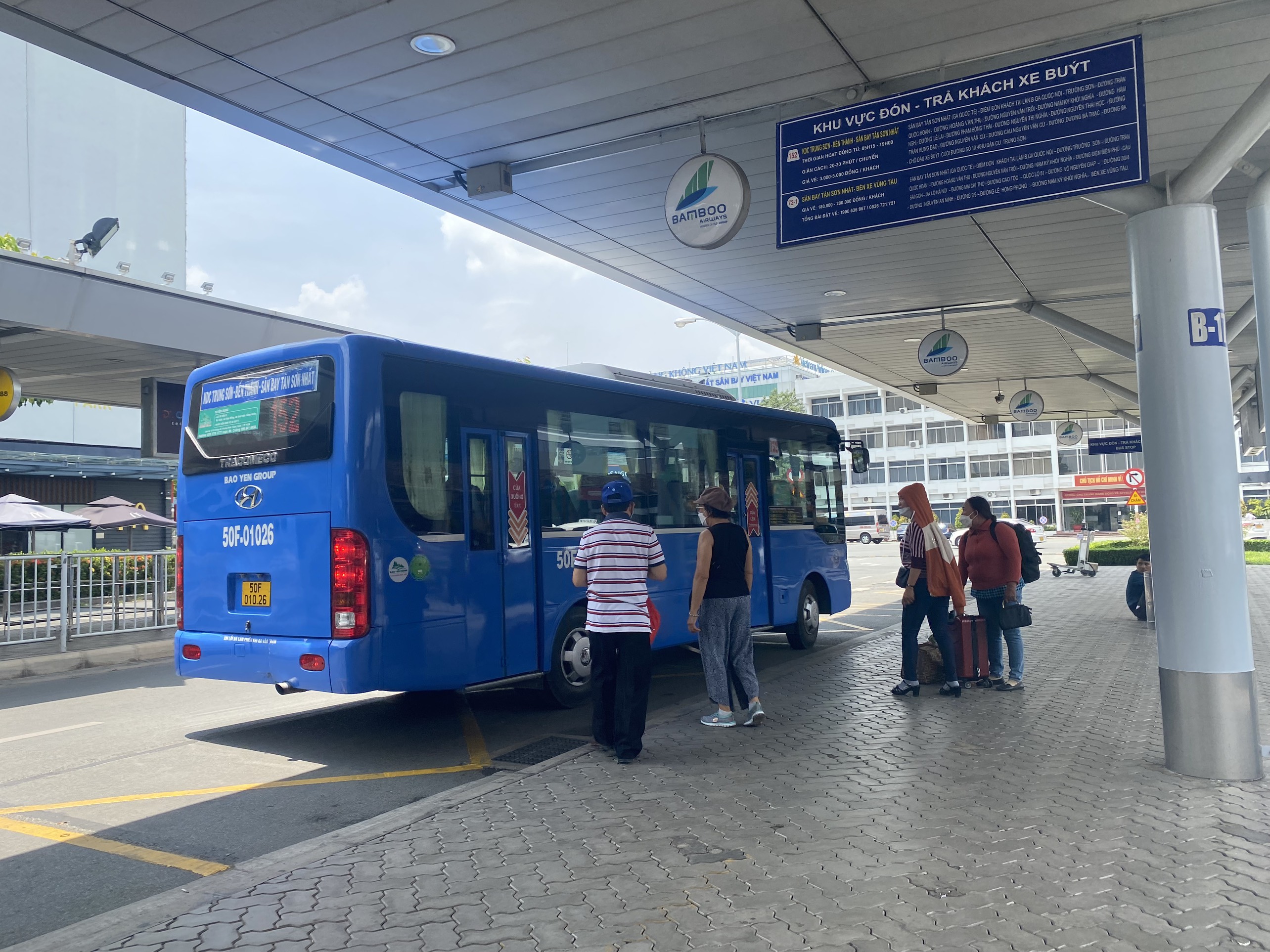 Airport shuttle bus boarding area at Tan Son Nhat International Airport in Ho Chi Minh City.