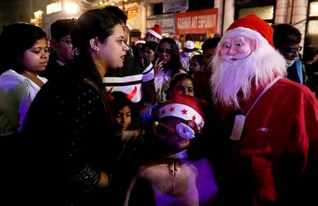 
People, dressed up as Santa Claus, were seen greeting visitors at various malls, gardens and churches in some cities. (PTI)
