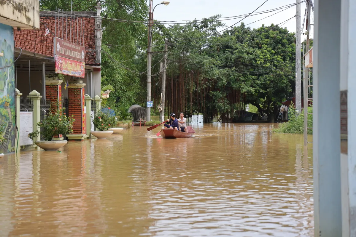 Hà Nội: Người dân thôn Bùi Xá di chuyển bằng thuyền do ngập - Ảnh 11.