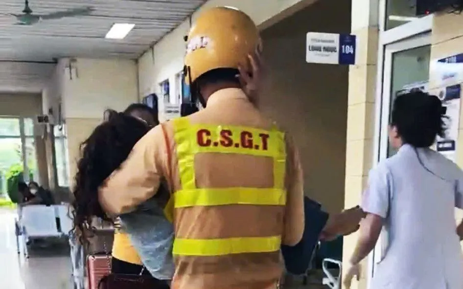 Chiến sĩ CSGT bế người phụ nữ đang bị co giật đến phòng cấp cứu. Chiến sĩ CSGT bế người phụ nữ đang bị co giật đến phòng cấp cứu.