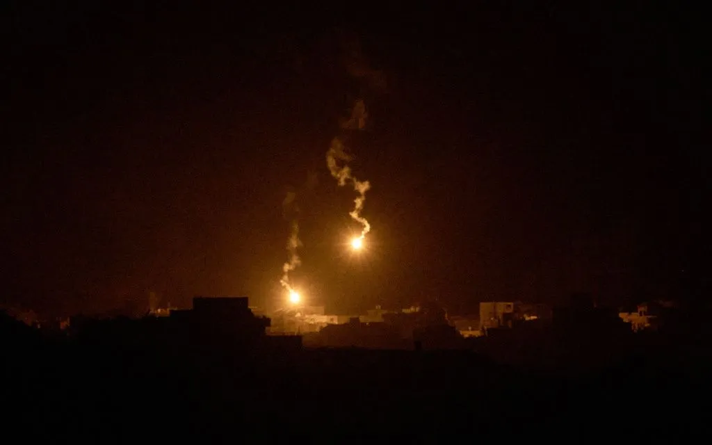 Pháo sáng của quân đội Israel bay qua các tòa nhà bị phá hủy ở phía Bắc Dải Gaza, ngày 24/9 (Ảnh: AP) Pháo sáng của quân đội Israel bay qua các tòa nhà bị phá hủy ở phía Bắc Dải Gaza, ngày 24/9 (Ảnh: AP)