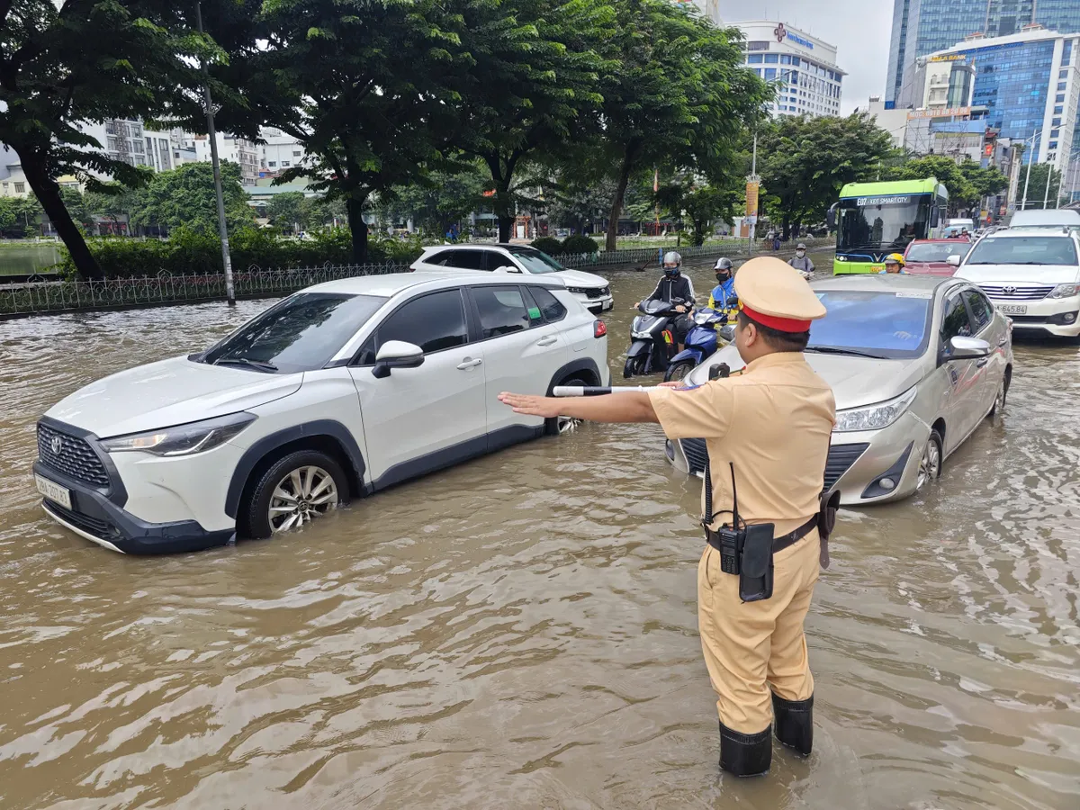 Hà Nội vẫn ngập sau mưa lớn, CSGT hỗ trợ đưa người dân qua điểm ngập, úng- Ảnh 5. Hà Nội vẫn ngập sau mưa lớn, CSGT hỗ trợ đưa người dân qua điểm ngập, úng- Ảnh 5.
