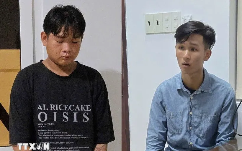 Hai đối tượng cướp giật Trương Vũ Khánh và Lê Quốc Trung Kiên tại cơ quan công an. (Ảnh: TTXVN phát)