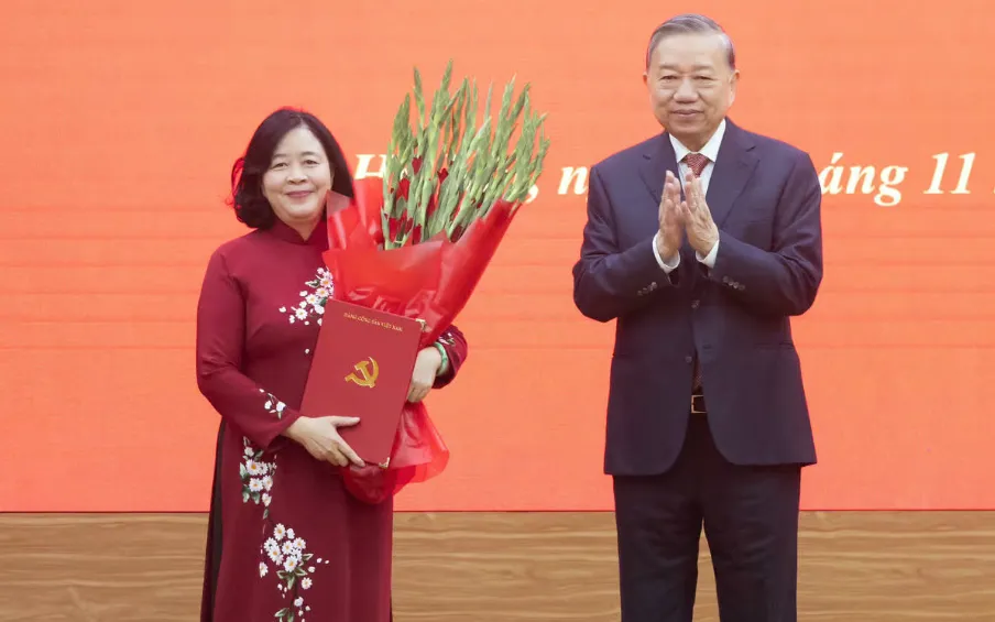 Tổng Bí thư Tô Lâm trao Quyết định của Bộ Chính trị và tặng hoa chúc mừng bà Bùi Thị Minh Hoài. (Ảnh: Quang Vinh)