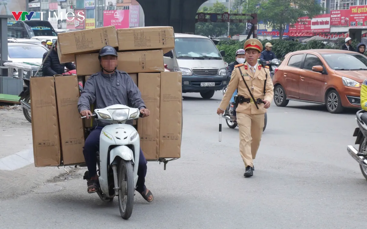 CSGT xử lý người điều khiển xe máy chở hàng hoá gây mất an toàn giao thông.