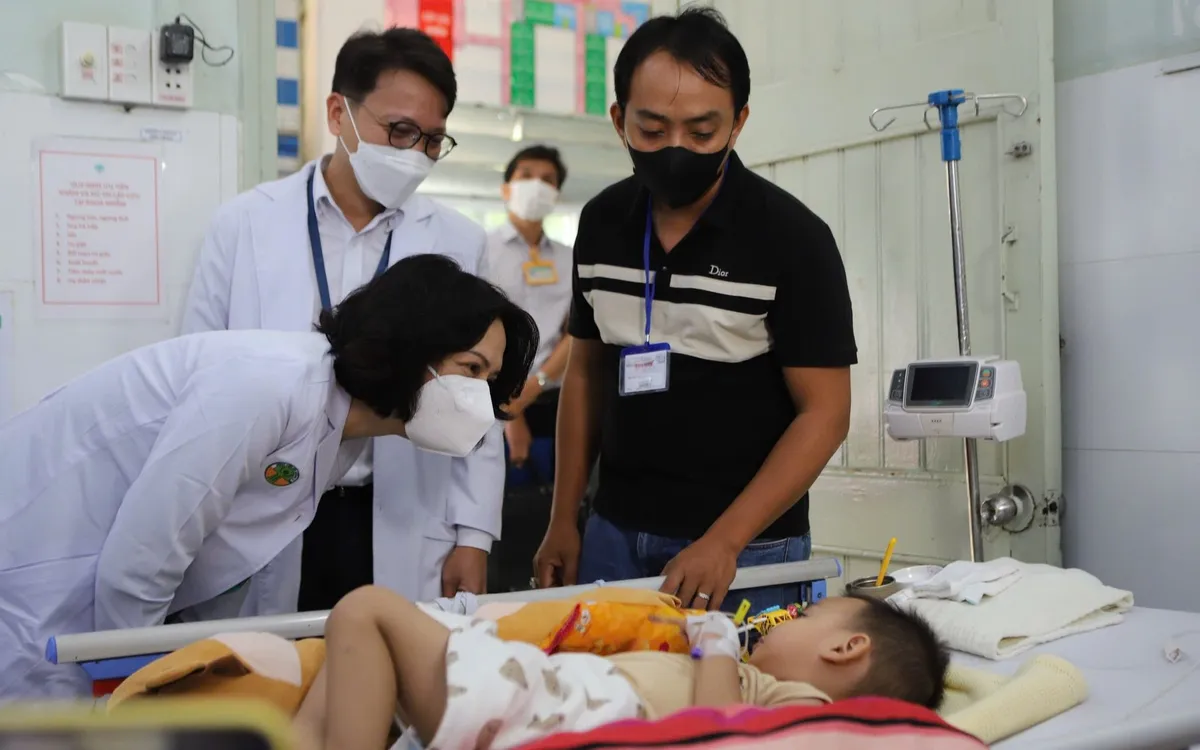 Thứ trưởng Bộ Y tế Nguyễn Thị Liên Hương thăm một bệnh nhi mắc tay chân miệng tại Bệnh viện Nhi đồng 2