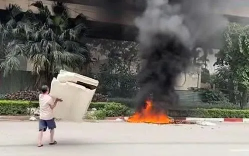 Ông T đốt xốp dưới gầm cầu Thăng Long. (ảnh: Cắt từ Clip)