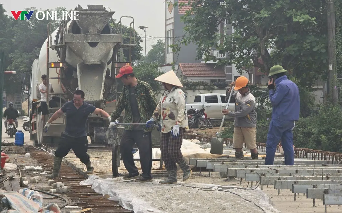 Công nhân khẩn trương thực hiện đổ bê tông, hoàn thiện mặt cầu theo đúng tiến độ.