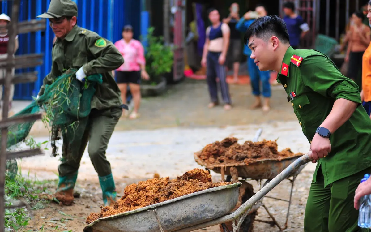 Từng xe đất đá được vận chuyển thủ công; tinh thần trách nhiệm của lực lượng Công an cơ sở góp phần giúp người dân sớm ổn định cuộc sống. Ảnh: Hoàng Anh