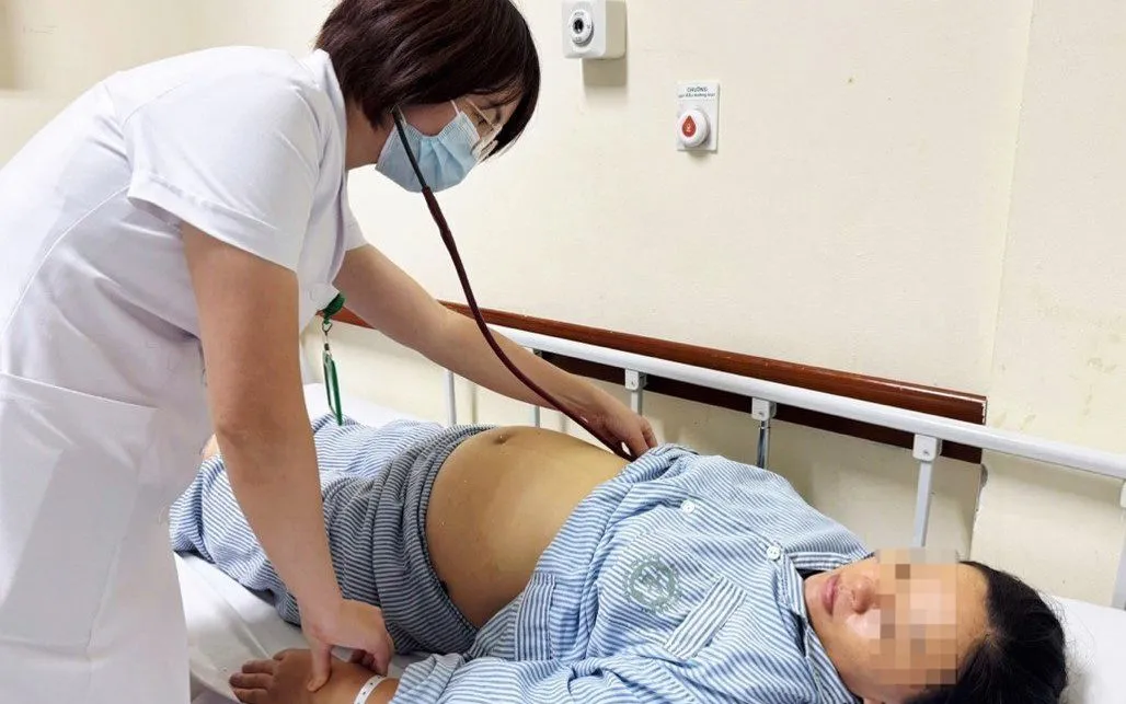 Bác sĩ Bệnh viện Bạch Mai thăm khám cho sản phụ bị viêm gan B đang điều trị tại đây.