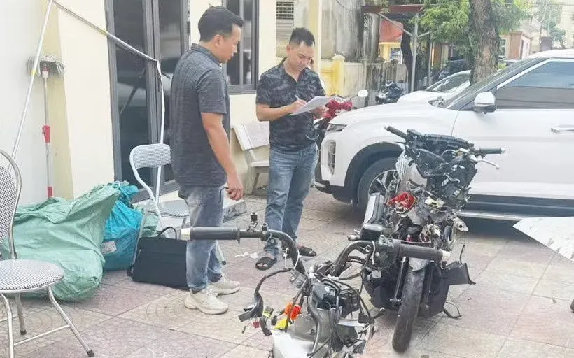 Lực lượng chức năng đang khám nghiệm xe môtô trong vụ tai nạn. Ảnh: Mạnh Tú/TTXVN