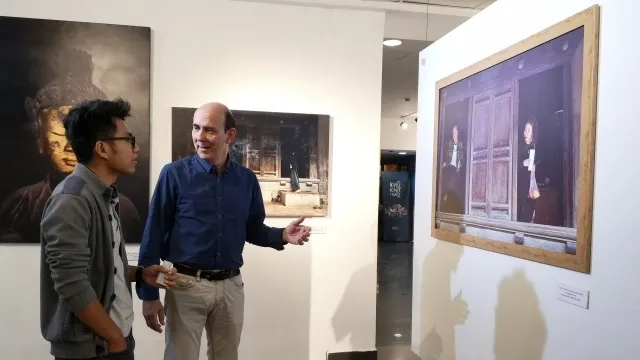 French photographer Nicolas Cornet (R) at the opening ceremony of the exhibition