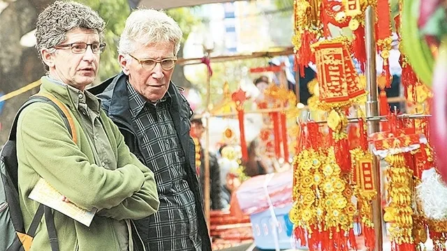 Visitors shopping at an area showcasing products for Tet (traditional Lunar New Year) festival in Hai Thuong Lan Ong Street, district 5