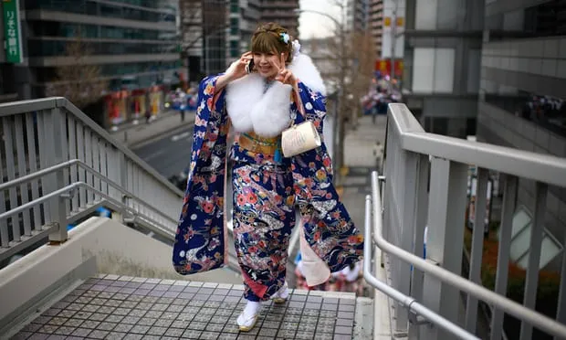 A woman leaves a coming of age ceremony, which are currently held when people reach the age of 20 (Photograph: Carl Court/Getty Images)