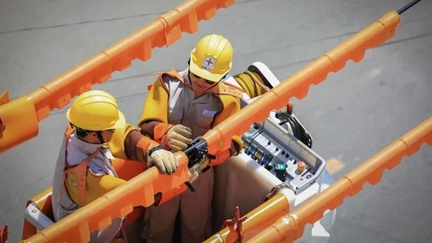 Line workers are repairing an electrical grid.