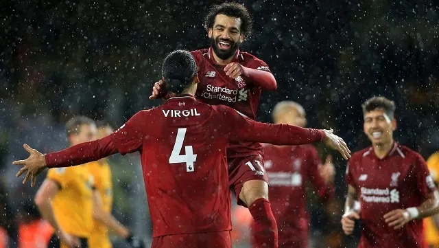 Mohamed Salah celebrates with Virgil van Dijk after scoring Liverpool’s first goal against Wolves during their Premier League clash on December 22, 2018. (Photograph: Getty Images)