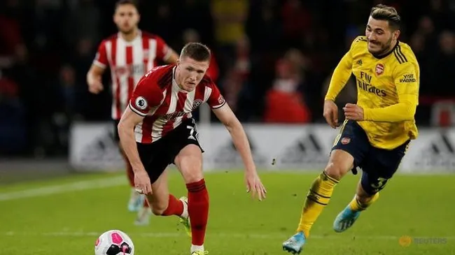 Soccer Football - Premier League - Sheffield United v Arsenal - Bramall Lane, Sheffield, Britain - October 21, 2019 Sheffield United's John Lundstram in action with Arsenal's Sead Kolasinac. (Reuters)
