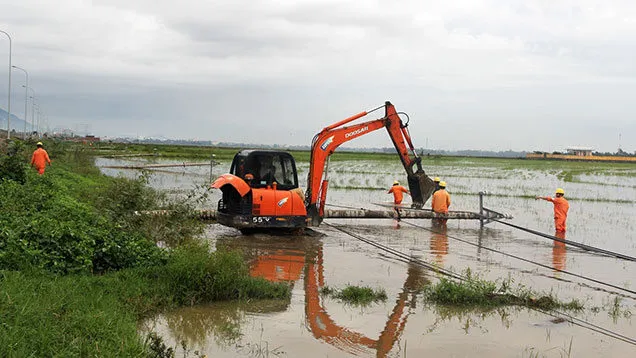 Workers of Phu Yen Power Company rebuild electricity poles downed by Storm Nakri in Dong Hoa District to restore power supply to customers. (Photo: NDO)
