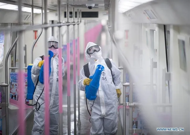 Staff members conduct disinfection on the subway train at a train depot in Wuhan, central China's Hubei Province, March 23, 2020. (Photo: Xinhua)