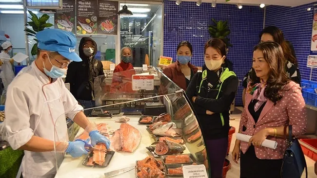 Local officials inspect the supply of goods at a supermarket in Hanoi.