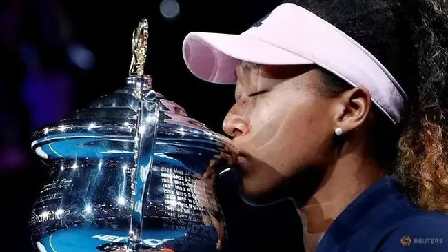 Japan's Naomi Osaka kisses her trophy after winning her match against Czech Republic's Petra Kvitova. (Reuters)