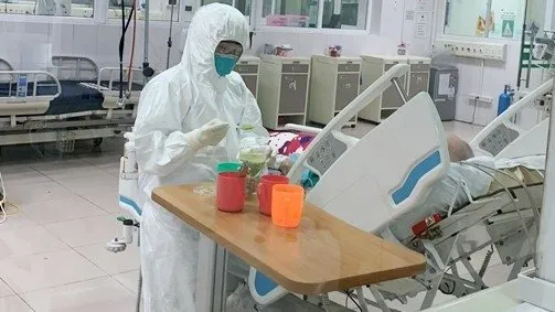 A health worker provides intensive care to a COVID-19 patient at the National Hospital of Tropical Diseases in Hanoi.