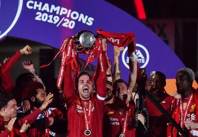 Liverpool's Jordan Henderson with team mates celebrates with the trophy after winning the Premier League. (Reuters)