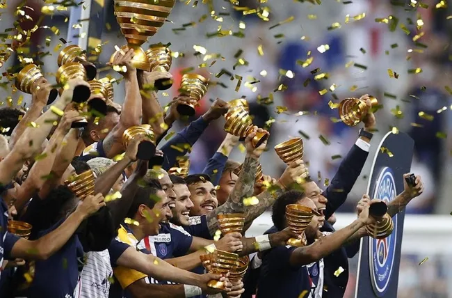 Paris St Germain players celebrate with the trophy after winning the Coupe de la Ligue, following the outbreak of the coronavirus disease. (Reuters)