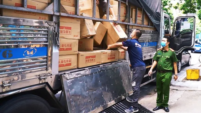 Hanoi police force checks a truck carrying smuggled moon cakes.