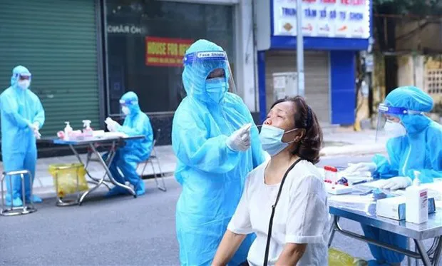 Collecting samples for COVID-19 testing (Photo: VNA)