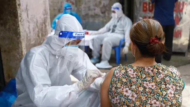 A woman is vaccinated against COVID-19.