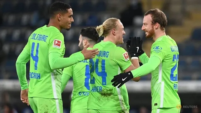 Wolfsburg's Maximilian Arnold celebrates scoring their third goal with teammates. (Reuters)