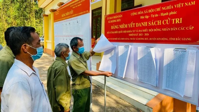 Voters look at lists of voters at a polling station in Bac Giang Province.