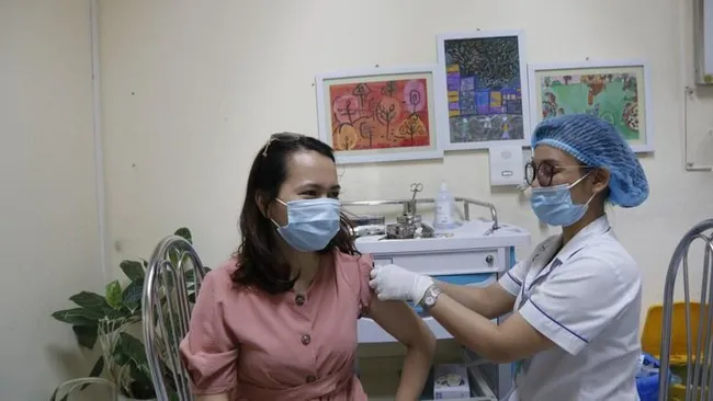 A woman is vaccinated against COVID-19.