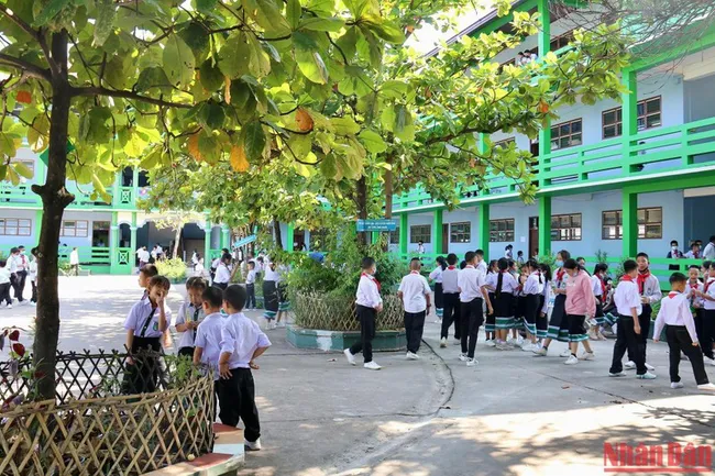 The shady trees on campus are the gathering place for many students during recess.