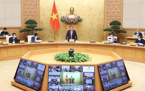 Prime Minister Pham Minh Chinh speaks at the meeting. (Photo: VNA)
