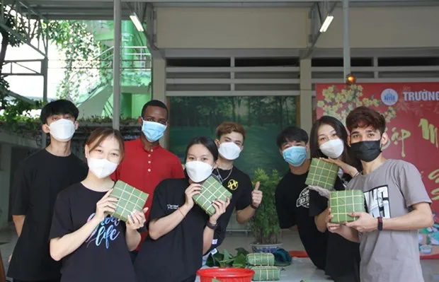 Lao students at Nha Trang University make Vietnamese traditional 'chung cakes' on the occasion of the Lunar New Year holiday. (Photo: VNA)