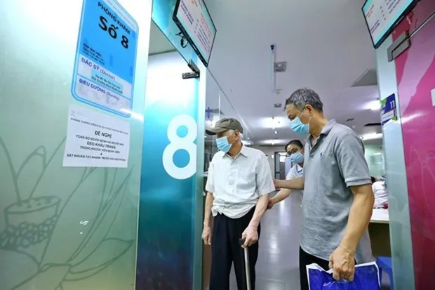 Senior citizens with high blood pressure prepare for a check-up in Hanoi. (Photo: VNA)