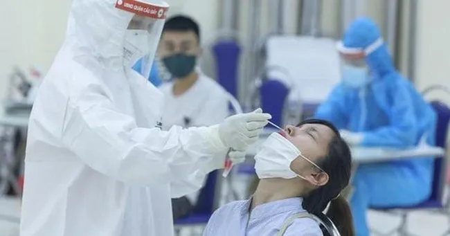 A health worker collects sample for COVID-19 testing.