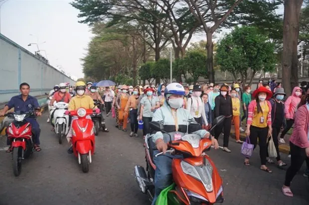 Workers at Pouyuen Company in HCM City leave at the end of the day. (Photo: baodansinh.vn)