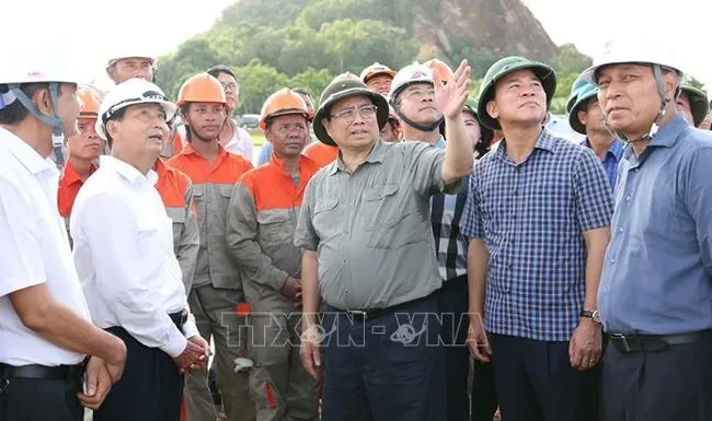 Prime Minister Pham Minh Chinh visits workers at the construction site of the project at Cau Loc commune of Hau Loc district, Thanh Hoa province (Photo: VNA)