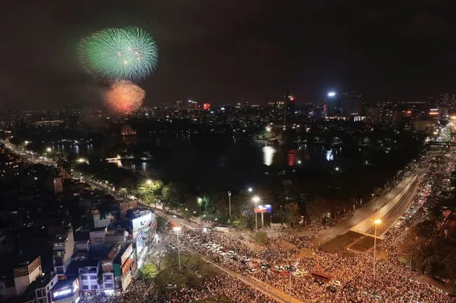 The capital city residents gather at Thong Nhat Park to watch the fireworks display.