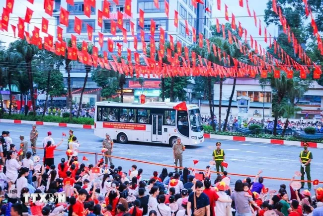 People gather on Van Cao street on August 27 to welcome the forces joining the preliminary state-level review for the National Day parade. (Photo: VNA)