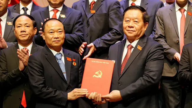 Chairman of the Party Central Committee's Commission for Information, Education, and Mass Mobilisation Nguyen Trong Nghia (R) presents the Politburo's decision to Thai Dai Ngoc, who now serves as Secretary of the Gia Lai provincial Party Committee. (Photo: VNA)
