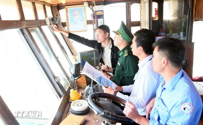 Checking voyage monitoring system on a fishing boat (Photo: VNA)