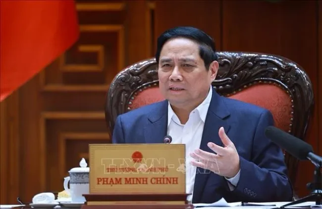 Prime Minister Pham Minh Chinh speaks at the meeting between the Government’s standing members and ministries, sectors and localities on December 16 on preparations for the ground-breaking and inauguration ceremonies for projects celebrating the 14th National Party Congress. (Photo: VNA)