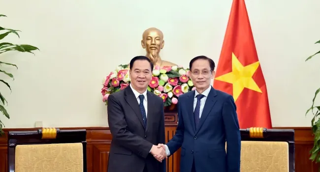 Minister of Foreign Affairs Le Hoai Trung (R) and Lao Minister of Education and Sports Thongsalith Mangnomek at their meeting in Ha Noi on December 16. (Photo: Vietnamese Ministry of Foreign Affairs)