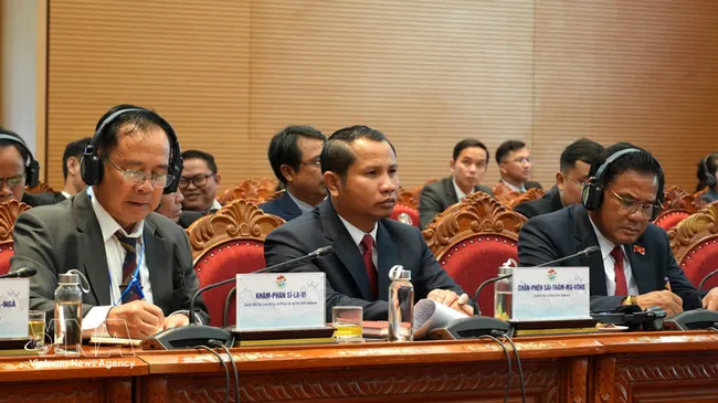 Lao delegates attend the conference. (Photo: VNA)