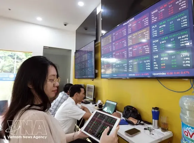 A customer conducts transactions at the headquarters of Bao Viet Securities Company. (Photo: VNA)